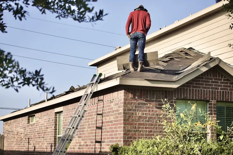 Professional roofer working on a residential roof in Mascoutah